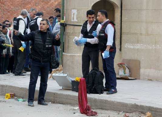 Police inspect the site of an attack on a church in the Helwan district south of Cairo