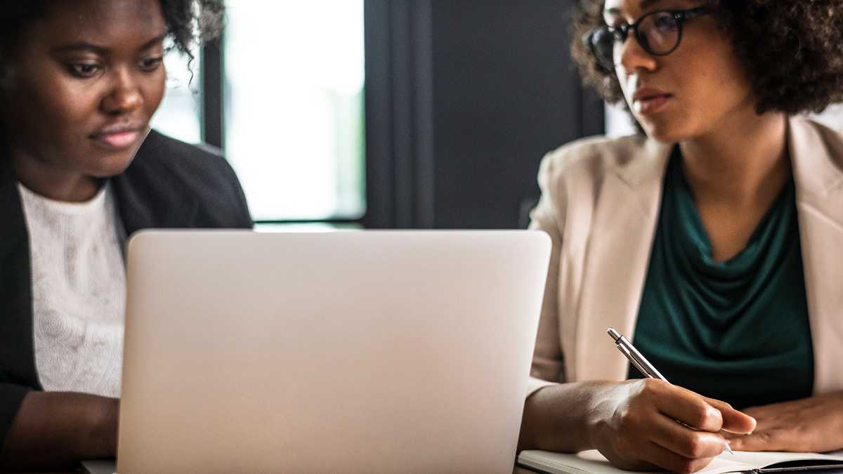 Deux femmes travaillant devant un ordinateur portable